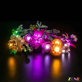 LED-lit LEGO Pretty Pink Flower Bouquet #10342 laid flat, showcasing colorful lighting effects on detailed floral construction set pieces.